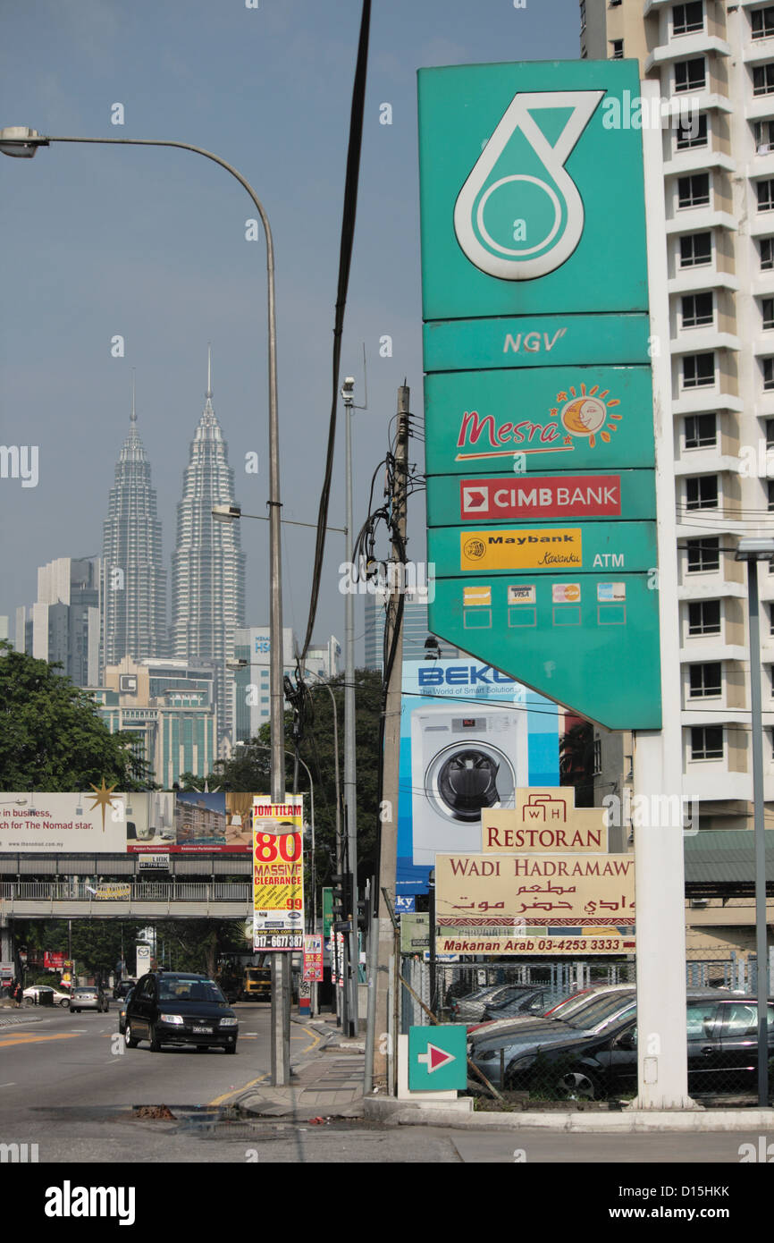 Scène de rue avec de nombreux logos de marques de Malaisie avec Petronas Twin Towers de l'arrière-plan Banque D'Images
