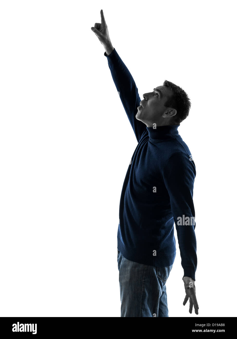 Un homme pointant vers le haut, surpris en pleine longueur ossature studio isolé sur fond blanc Banque D'Images