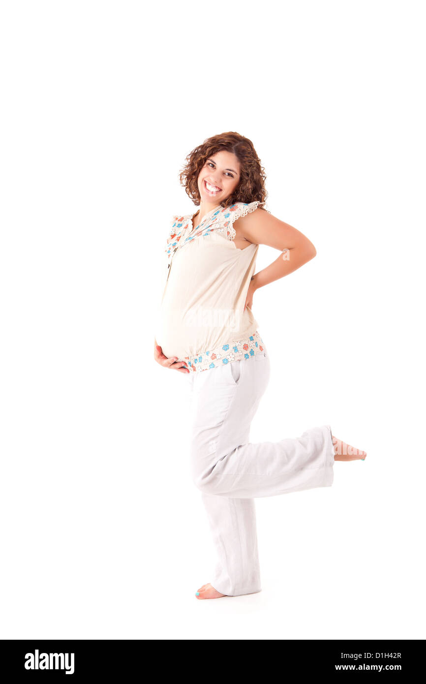 Belle femme enceinte montrant sa bonne forme sur fond blanc Banque D'Images