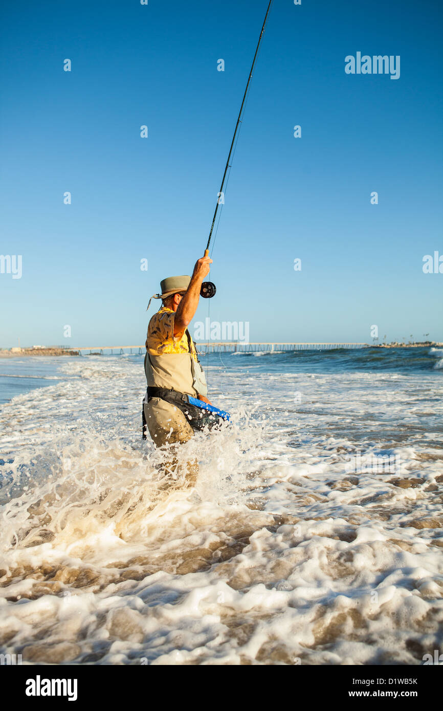 Fly fisherman casting pour surfer sur la perche, La Conchita Plage Près de Carpinteria, en Californie, États-Unis d'Amérique Banque D'Images