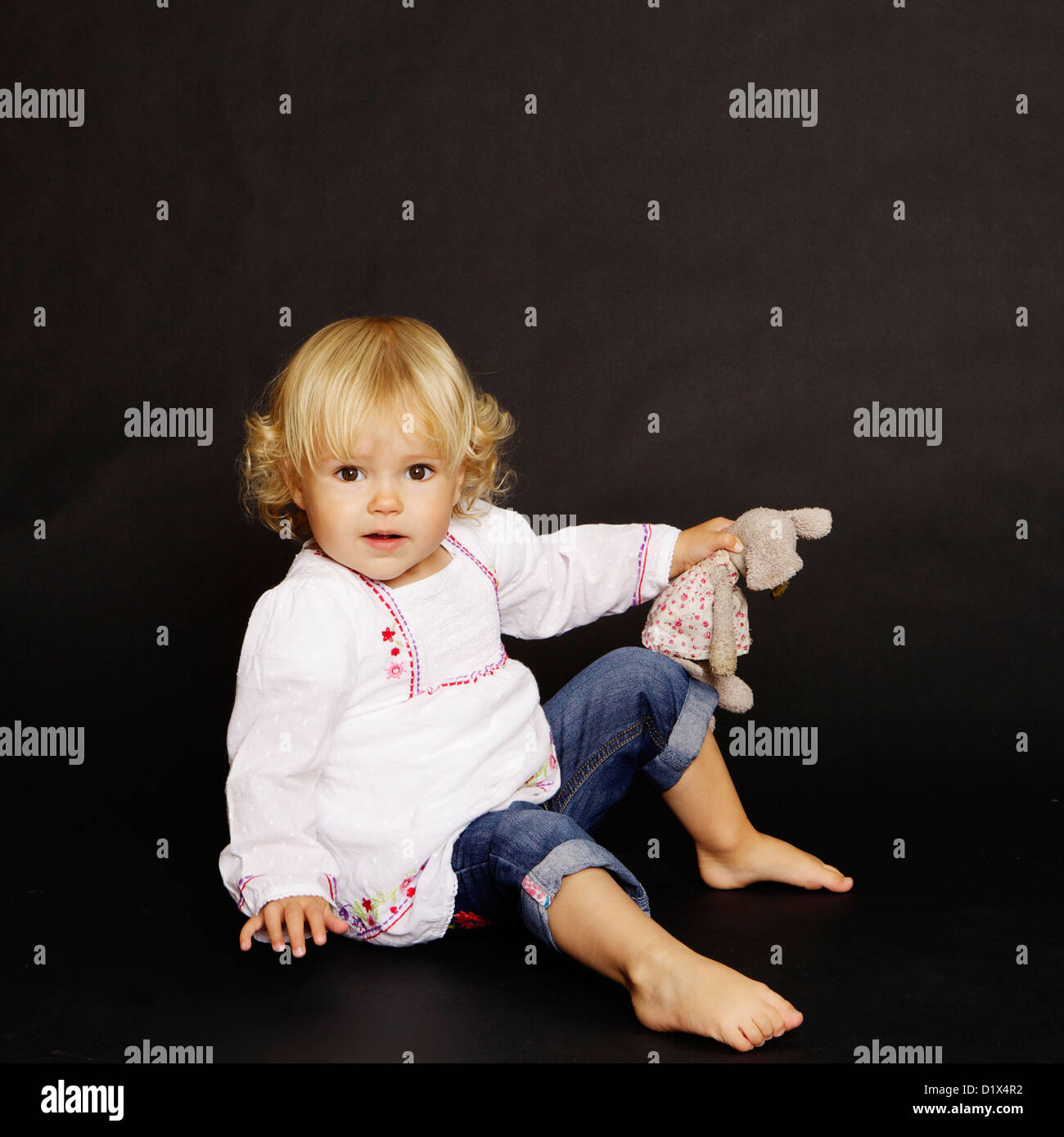 Deux Ans Bebe Fille Blonde En Chemise Blanche Et Denim Sur Fond Noir Photo Stock Alamy