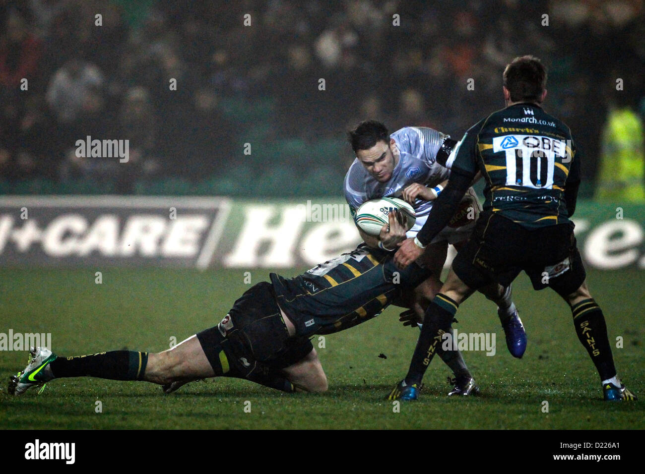 11.01.2013 Northampton, en Angleterre. Max EVANS de Castres Olympique est abordé par Tom Wood (à gauche) et Stephen MYLER (droite) de Northampton Saints au cours de la Heineken Cup match entre Northampton Saints et Castres Olympique à Franklin's Gardens. Score final : Northampton Saints 18-12 Castres Olympique. Banque D'Images