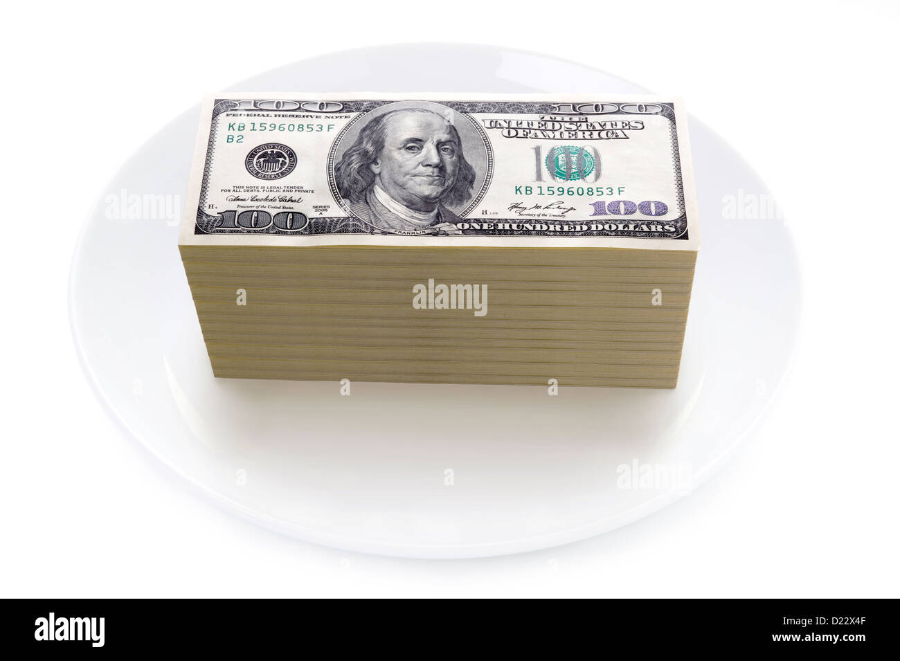 Prix des aliments ou des prix de l'alimentation pile de concept one hundred dollar bills sur une plaque isolés contre fond blanc Banque D'Images