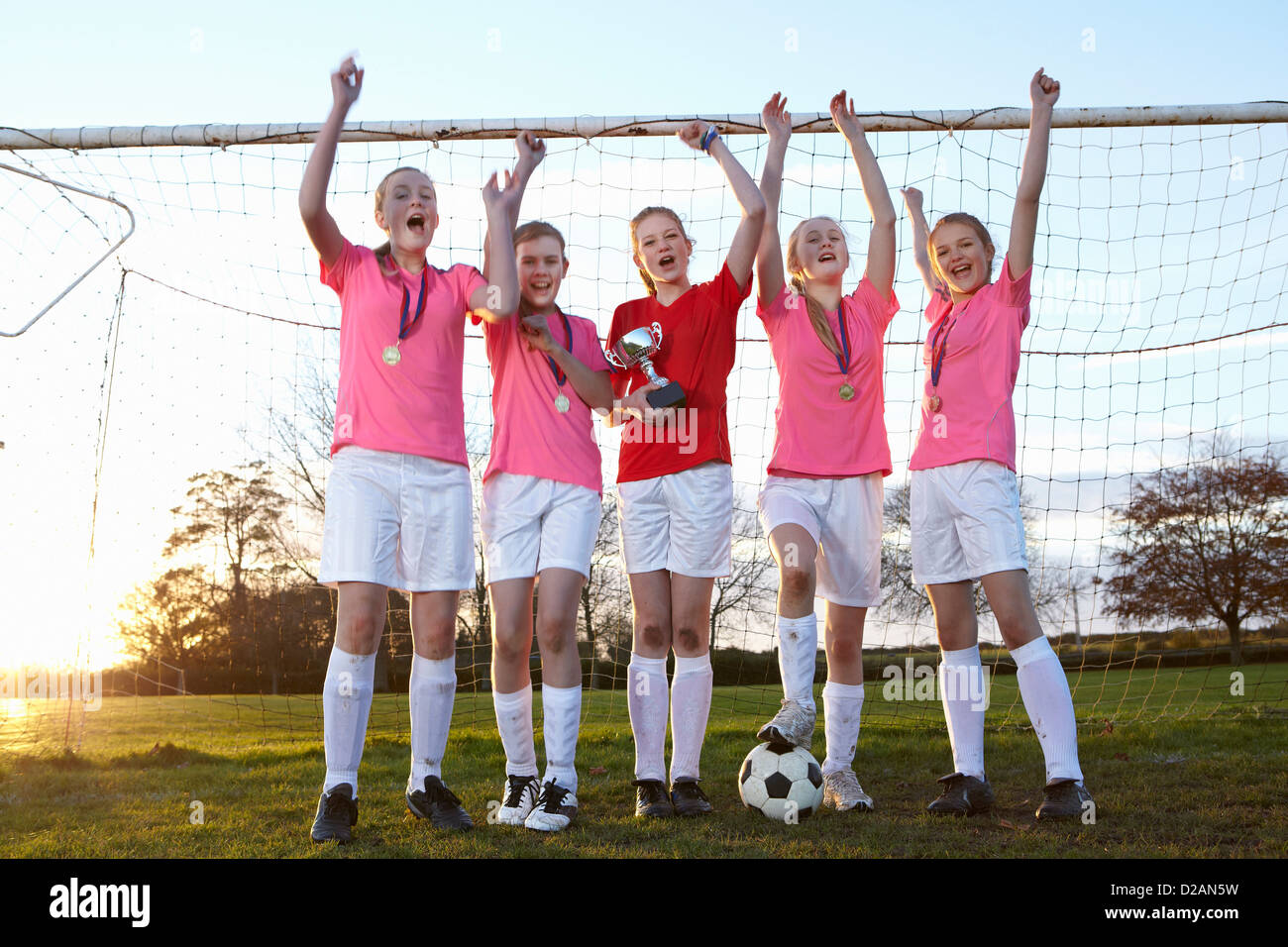 L'équipe de football cheering in field Banque D'Images