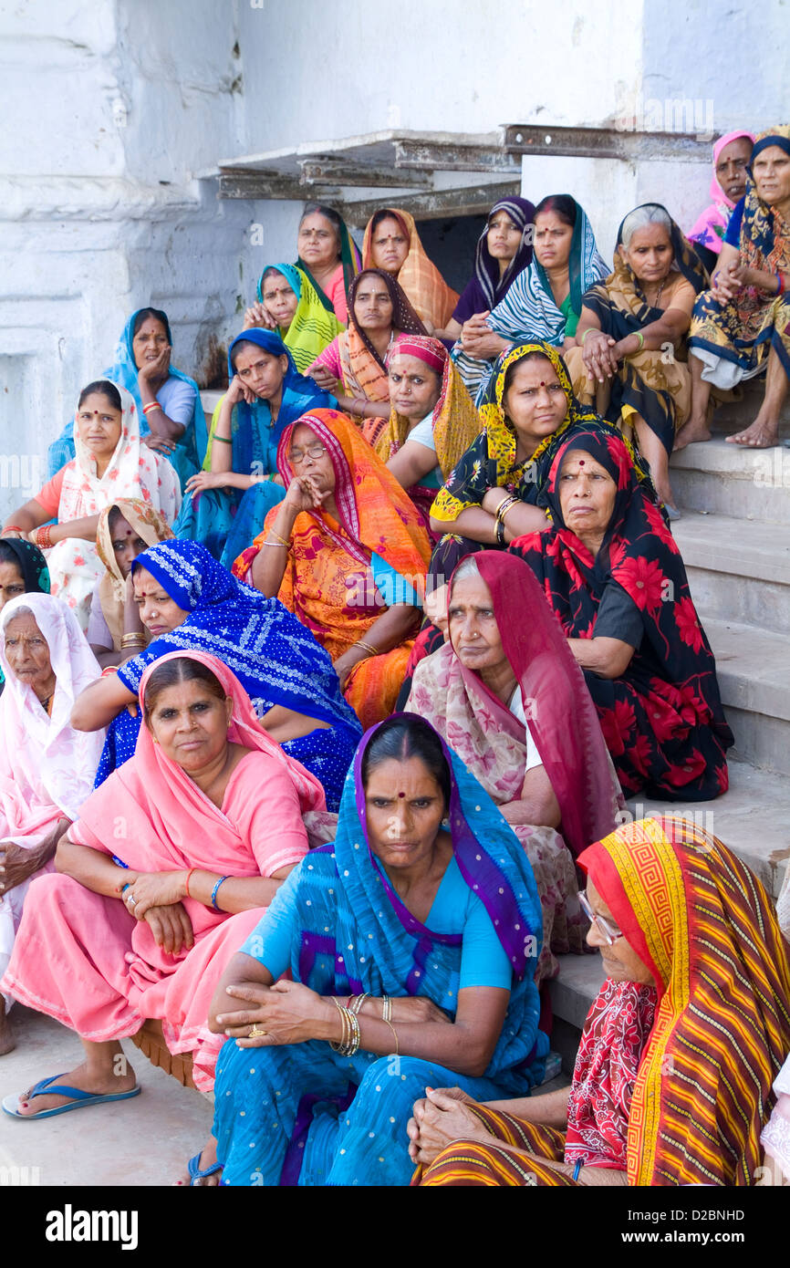 Les femmes hindoues en costumes et voiles assise sur les marches en attente de bateau dans le village de religieux de l'Inde Mathura Banque D'Images