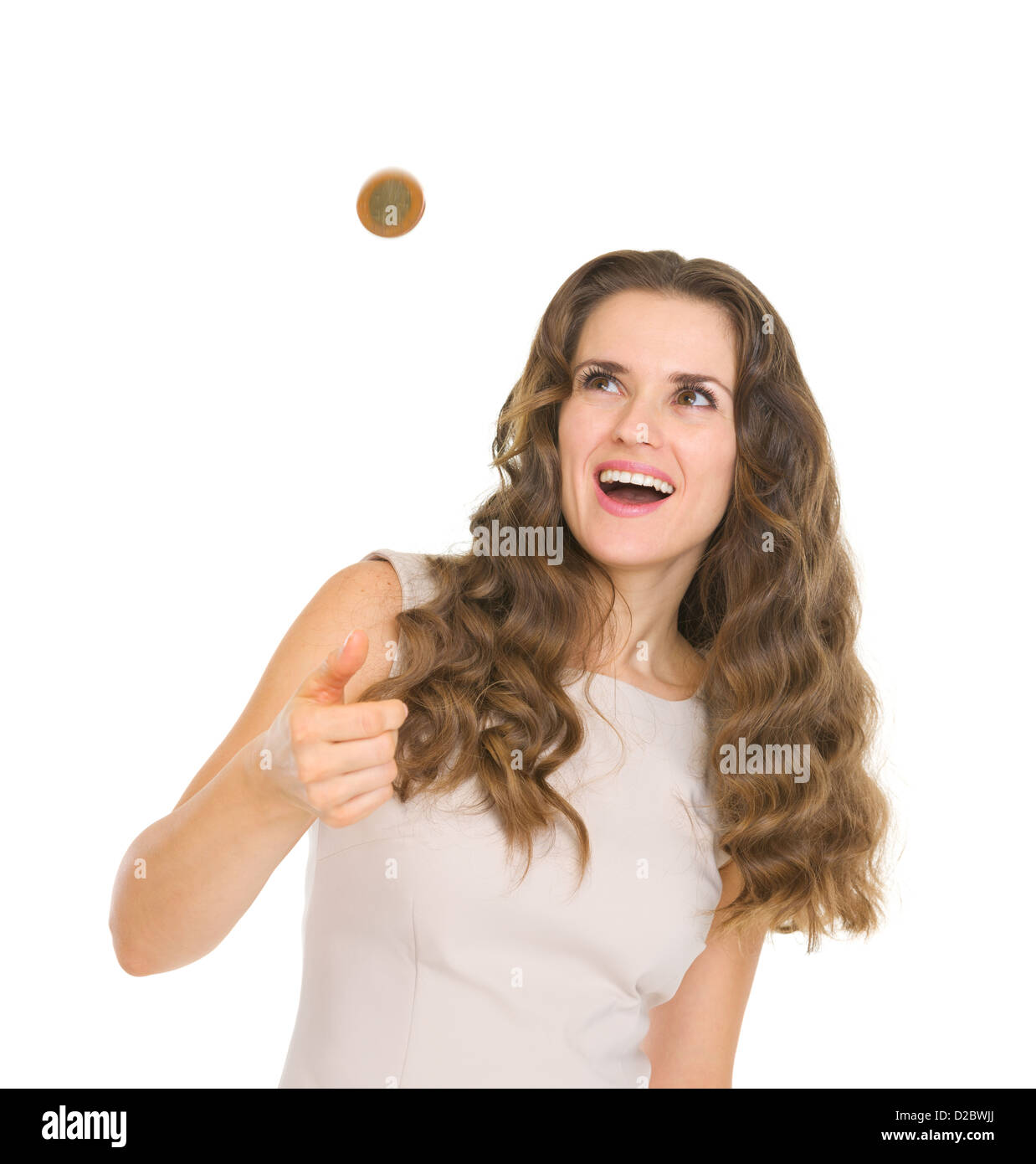 Happy young woman tossing coin Banque D'Images