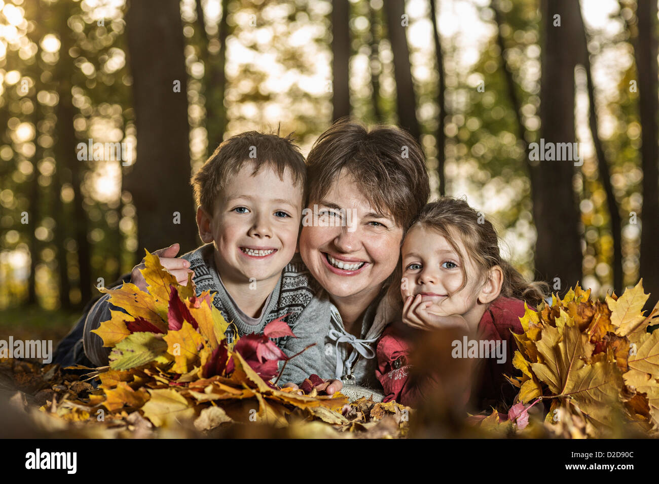 Une grand-mère posant avec deux de ses petits-enfants dans la nature Banque D'Images