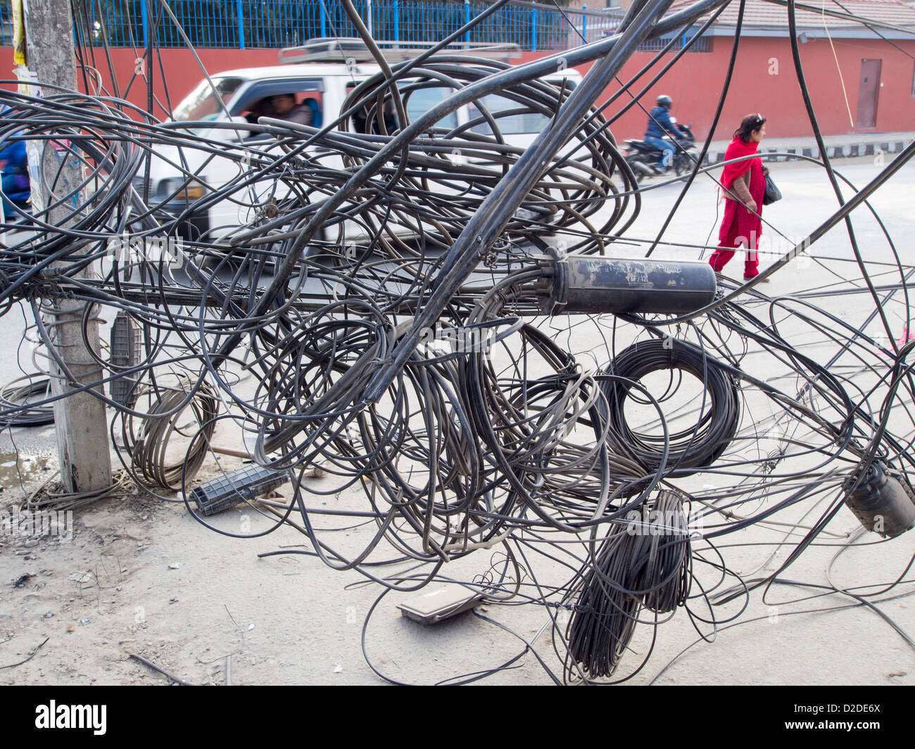 Un électricien travaille sur un enchevêtrement de fils électriques à Katmandou, au Népal. Banque D'Images