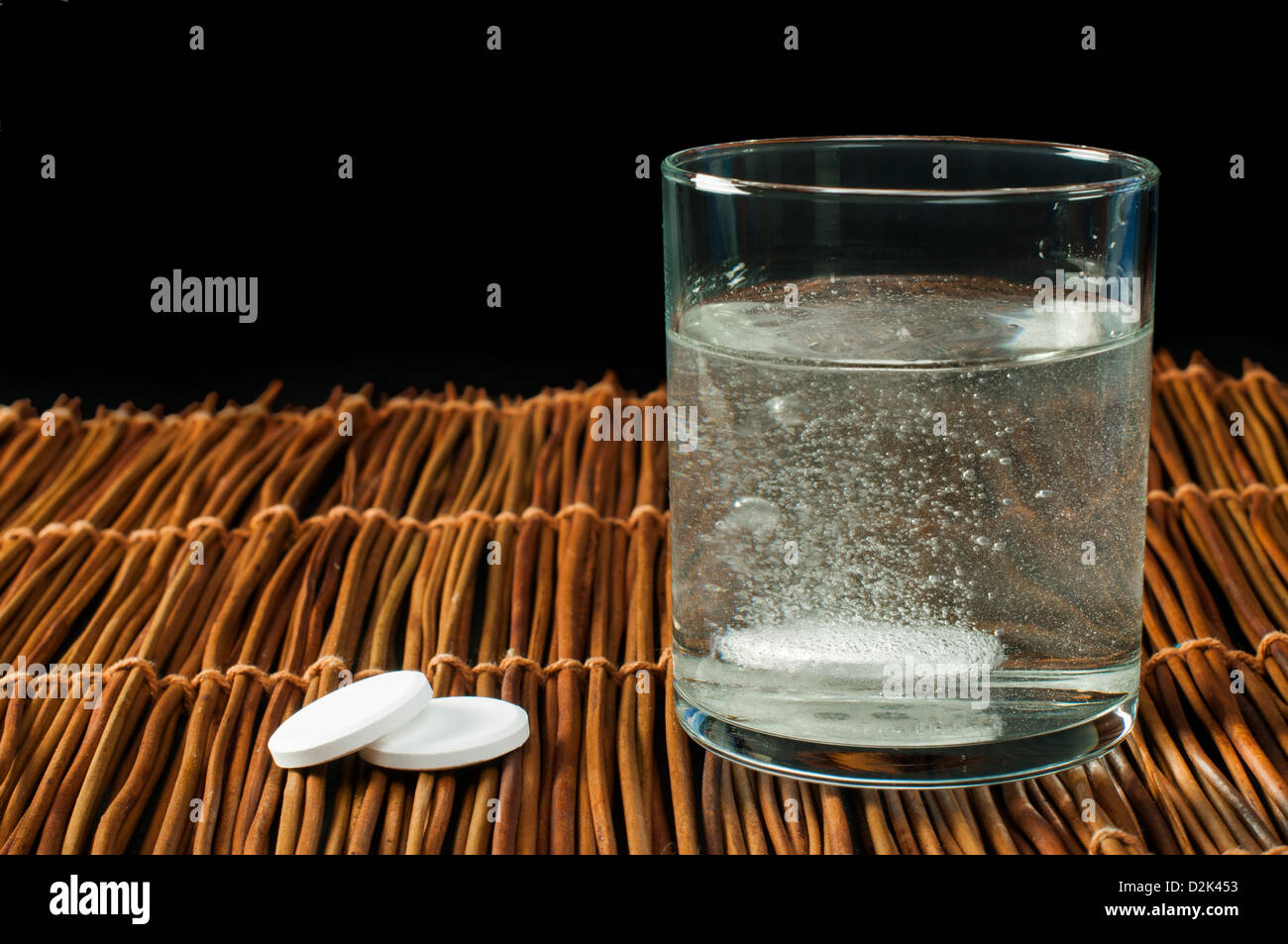 L'aspirine soluble dans l'eau. Verre d'eau et des pilules. Banque D'Images