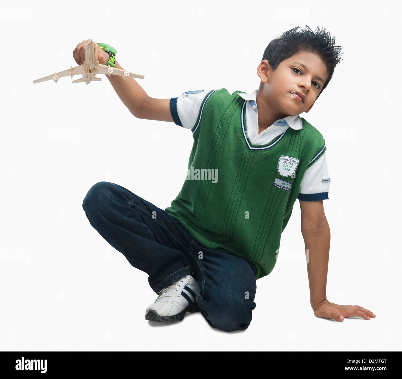 Portrait of a boy playing with a toy airplane Banque D'Images