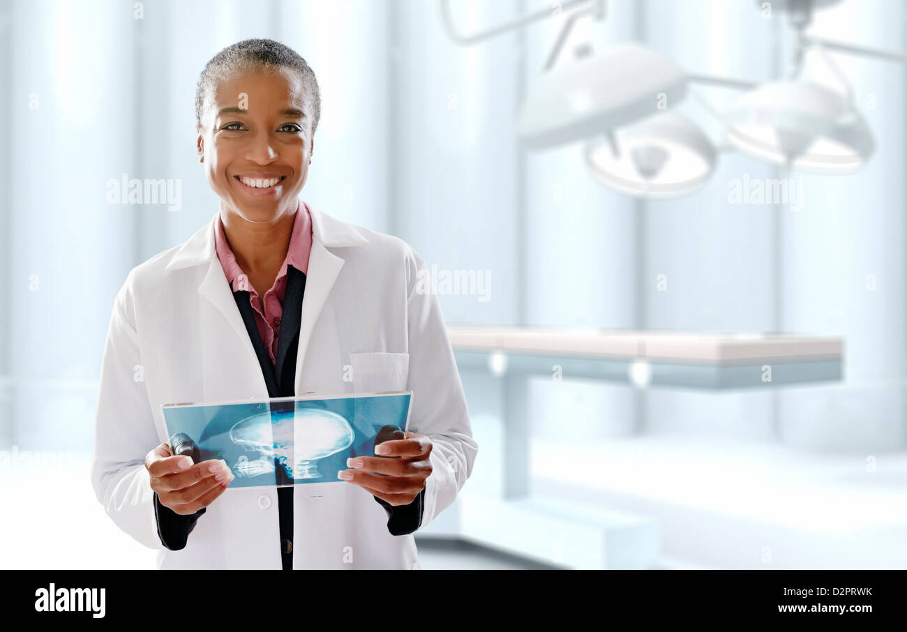 Black doctor holding digital tablet in operating room Banque D'Images Black doctor holding digital tablet in operating room Banque D'Images