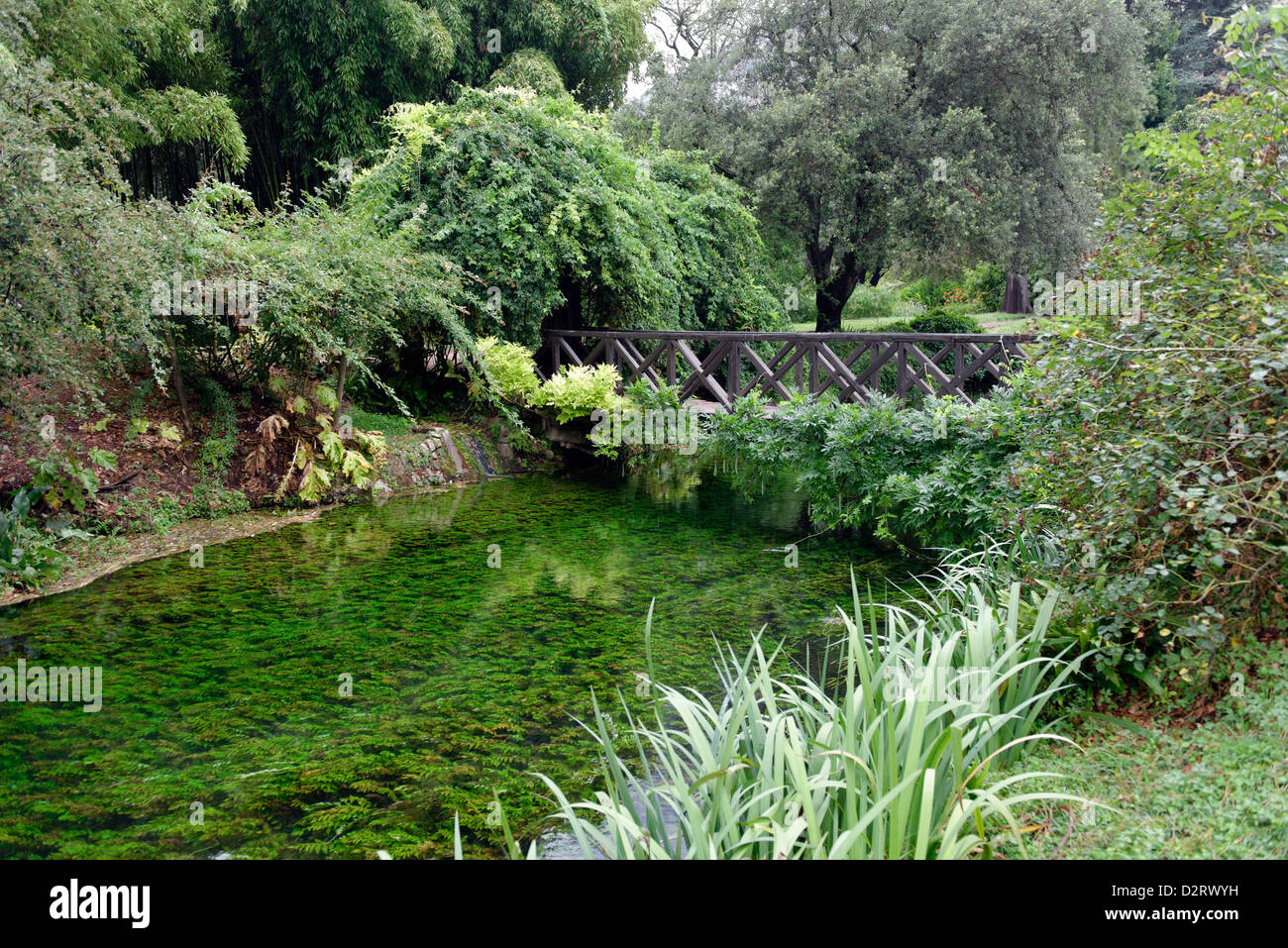 Le pont de bois appelé Ponte di Legno traversant la rivière. Jardin de Ninfa. Le Latium. Italie Banque D'Images