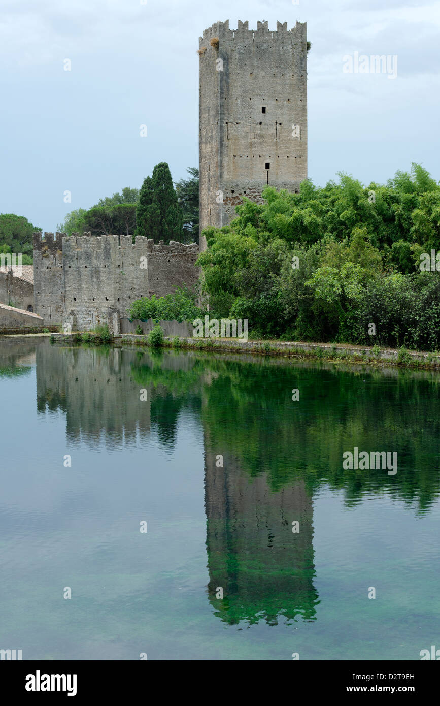 La tour du château médiéval et du lac à la magnifique et romantique jardin de Ninfa. Cisterna di Latina, Latium, Italie Banque D'Images