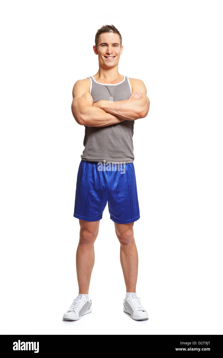 Jeune homme musclé en tenue de sport bras croisés smiling on white background Banque D'Images