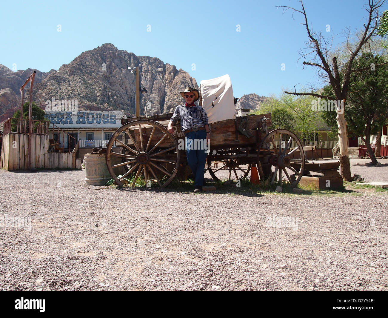 Cowboy debout à côté de stagecoach dans wild west town Banque D'Images