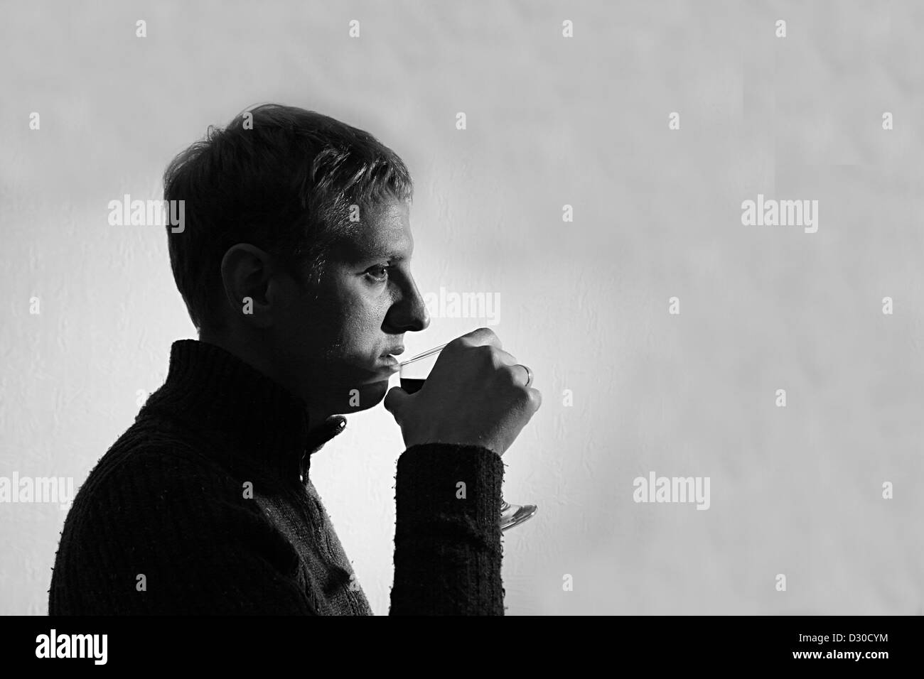 Jeune homme boire du vin, noir et blanc Banque D'Images