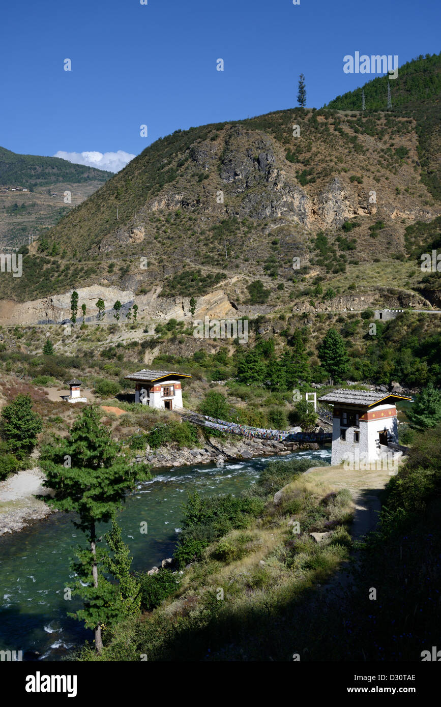 Fer à repasser bhoutanais chain bridge crossing river à un petit monastère, le pont est couvert de drapeaux de prière,36MPX Banque D'Images