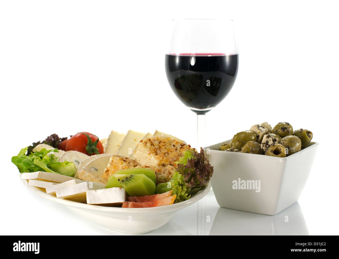 Assiette de fromage avec le vin rouge et les olives sur fond blanc Banque D'Images