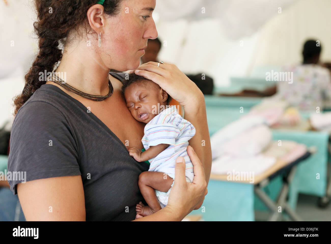 Carrefour, Haïti, Croix Rouge, Aerztin est titulaire d'un bébé dans les bras  à l'hôpital Photo Stock - Alamy