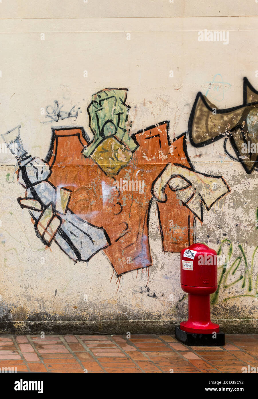 Le Graffiti représentant une figure stylisée qui suggère un génie dans un turban tenant une bouteille ou flacon et un chiffon ou une serviette Banque D'Images