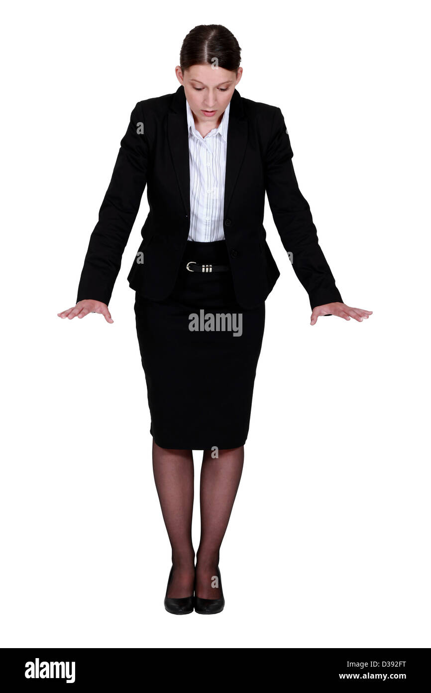 Businesswoman essayant de garder son équilibre Banque D'Images