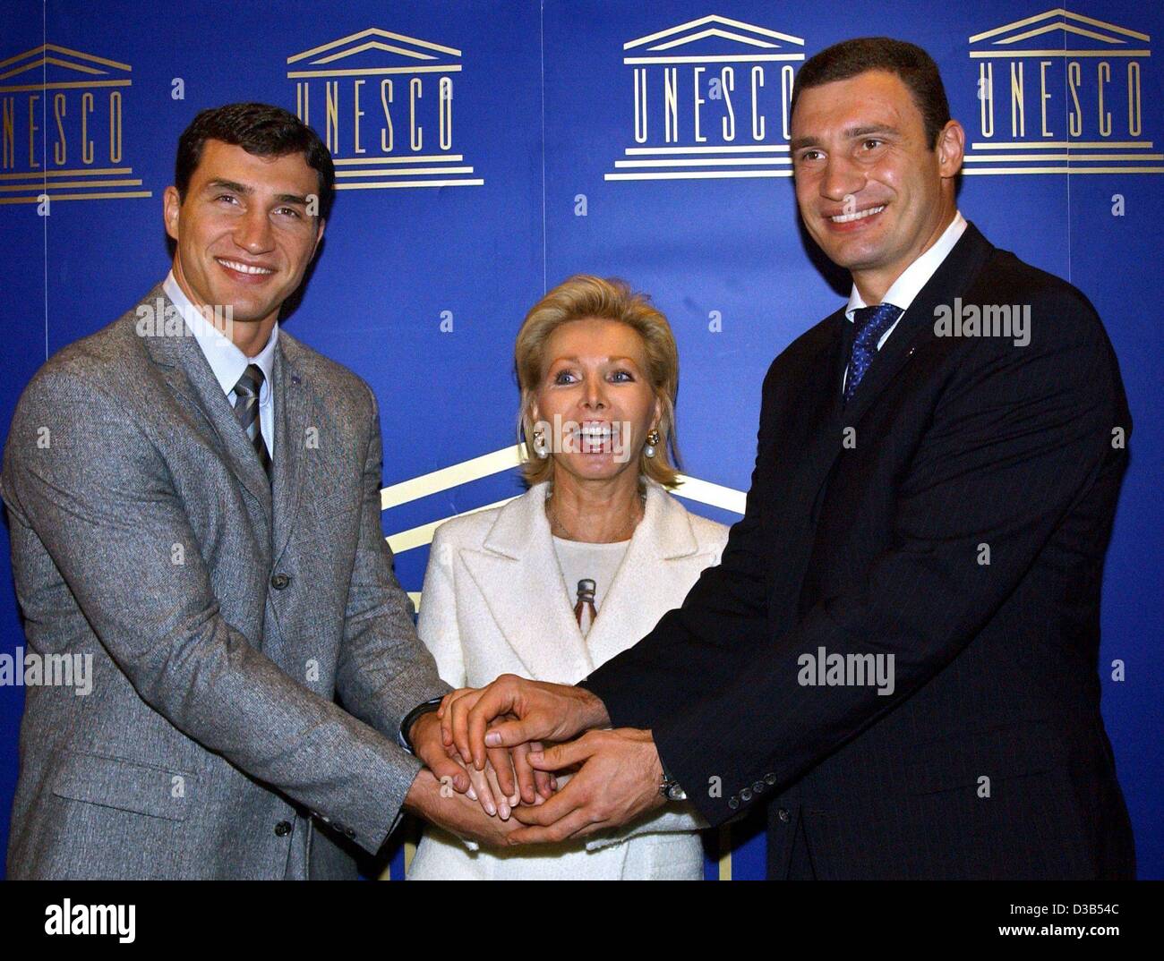 (Afp) - Dans un geste symbolique, l'ambassadeur de l'UNESCO Ute-Henriette Ohoven et les frères de boxe Vladimir (L) et Vitali Klitschko joignent leurs mains au cours d'une conférence de presse à Düsseldorf, 25 septembre 2002. Le projet de l'UNESCO "l'éducation pour les enfants dans le besoin", lancé par Ohoven, commencé un partenaire Banque D'Images