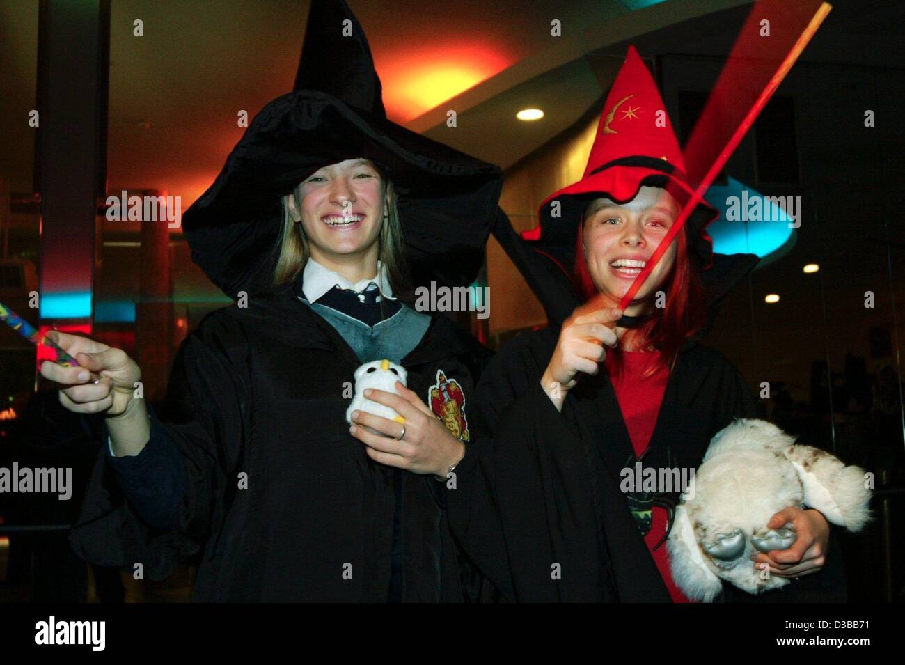 (Afp) - Deux fans déguisés en sorciers vague leurs baguettes qu'ils arrivent pour la première de minuit le nouveau film Harry Potter à Berlin, 13 novembre 2002. "Harry Potter et la Chambre des Secrets", le second film, Potter a été créée une minute après minuit dans 35 salles de cinéma à Berlin. Banque D'Images