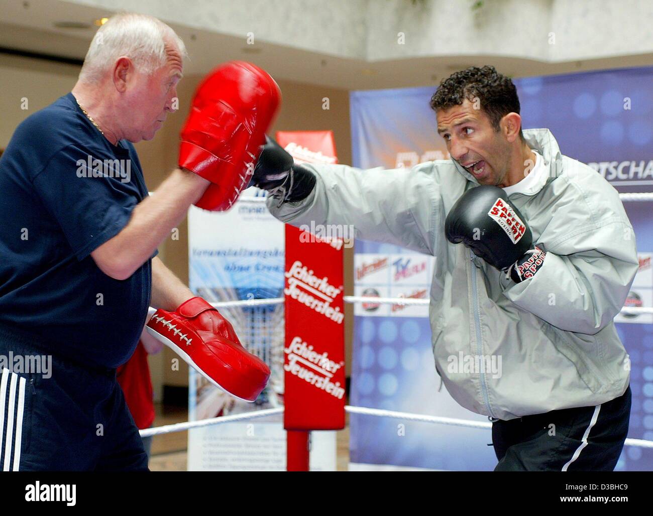 (Afp) - 33 ans Oktay Urkal, champion d'Europe dans la catégorie cruiser, poids des exercices avec son entraîneur Ulli Wegner duringan formation ouverte pour la presse à Magdeburg, Allemagne, 10 juin 2003. Urkal défendra son titre pour la deuxième fois contre challenger britannique Eamonn Magee le 14 juin 2003. Banque D'Images