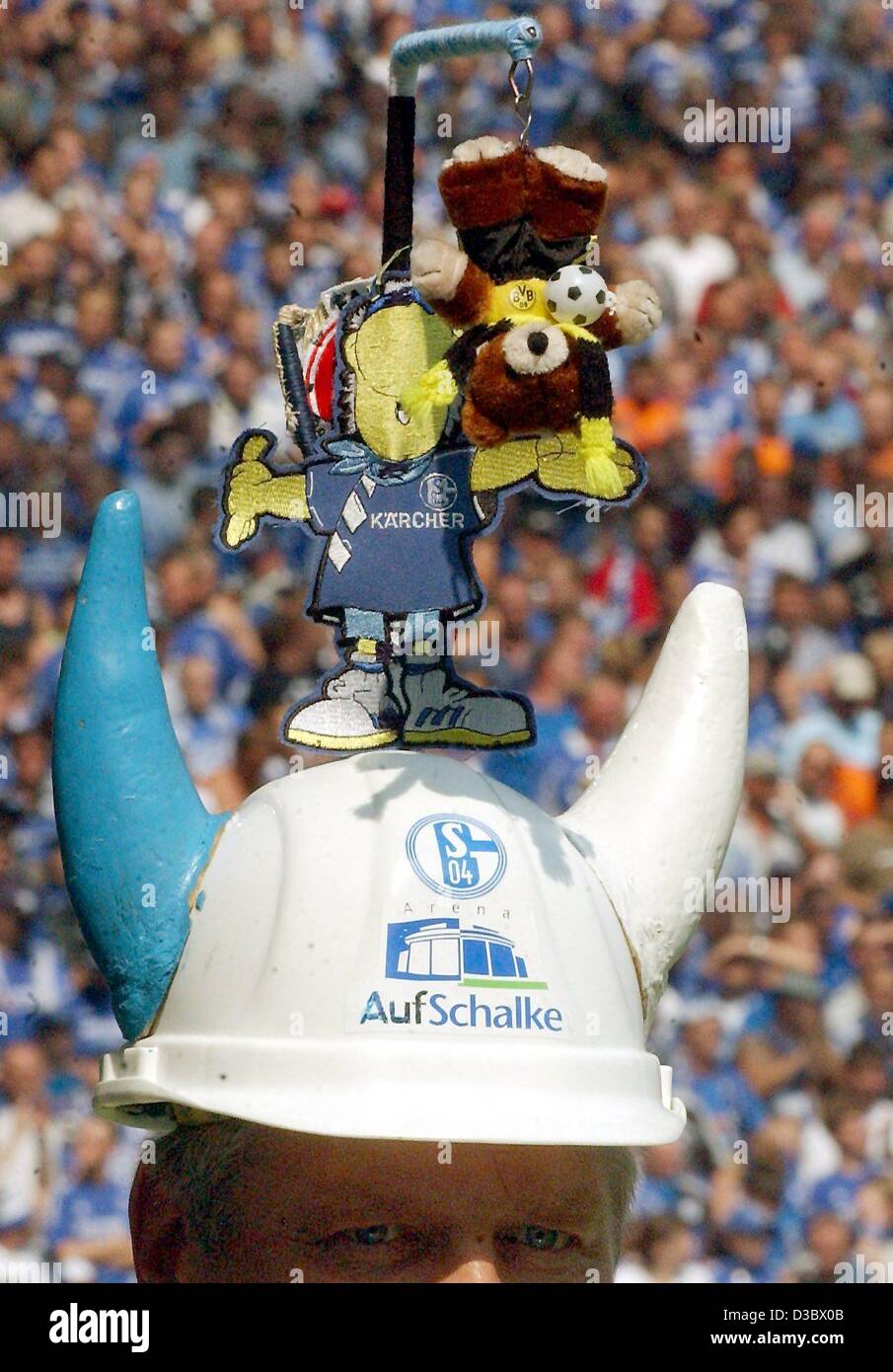 (Afp) - un fan de la German soccer club Schalke 04 porte une coiffure inhabituelle, montrant un ours vêtus aux couleurs du club rival Borussia Dortmund accroché à une potence et un heureux Schake teddy monté sur un casque de sécurité, lors d'un match de Bundesliga contre Schalke 04 Borussia Dortmund et à l'al. Banque D'Images