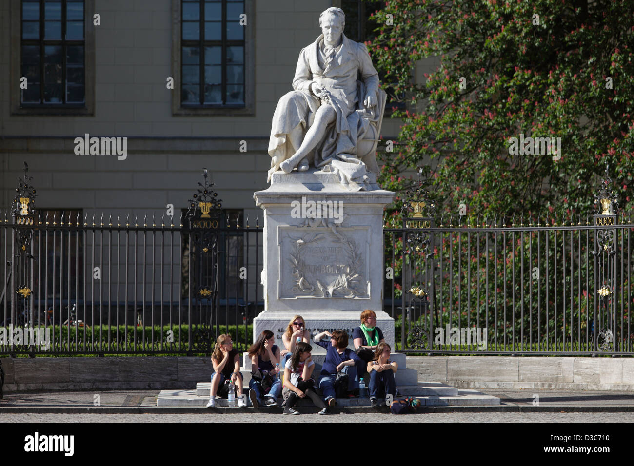 Berlin, Allemagne, les jeunes gens assis sur le socle du monument d'Alexander von Humboldt Banque D'Images
