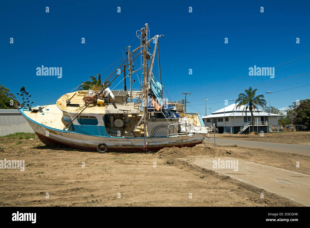 Chalutier de pêche rejetés sur la terre à côté de route et maisons dans l'est de Bundaberg après les inondations en 2013 Banque D'Images