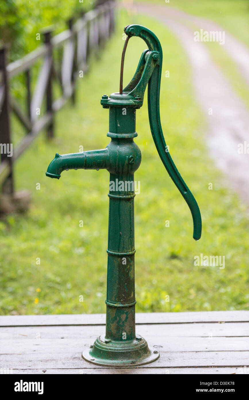 La main à l'ancienne pompe à eau verte en milieu rural, la Suède Banque D'Images