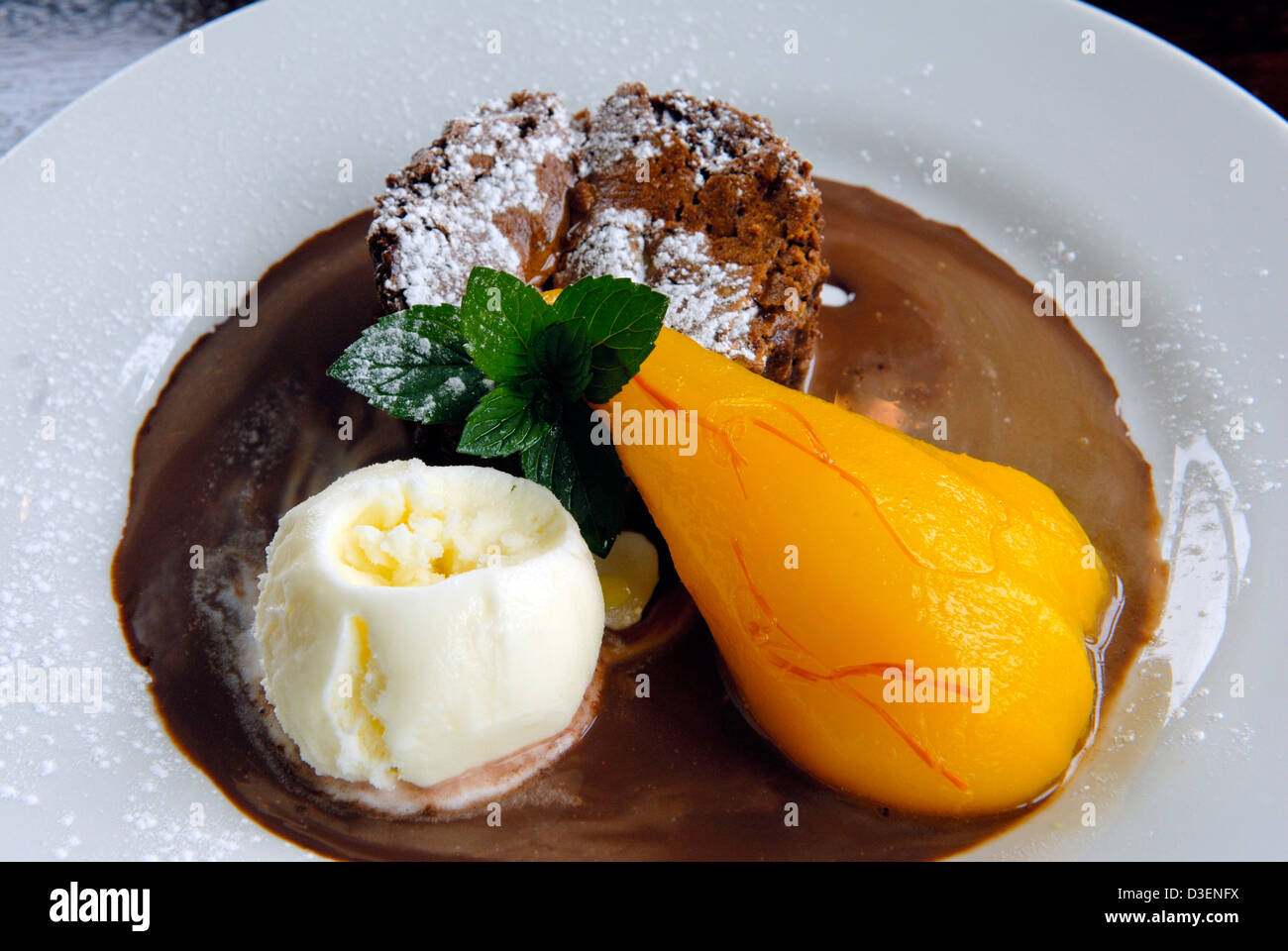 Brownie au chocolat avec du miel et du safran poire pochée et glace vanille dessert at a restaurant Shropshire Banque D'Images