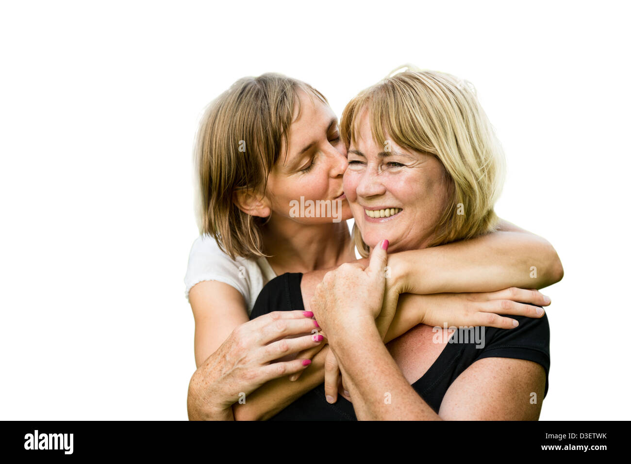 Portrait of happy mother embrassé par sa fille adulte - isolated on white Banque D'Images