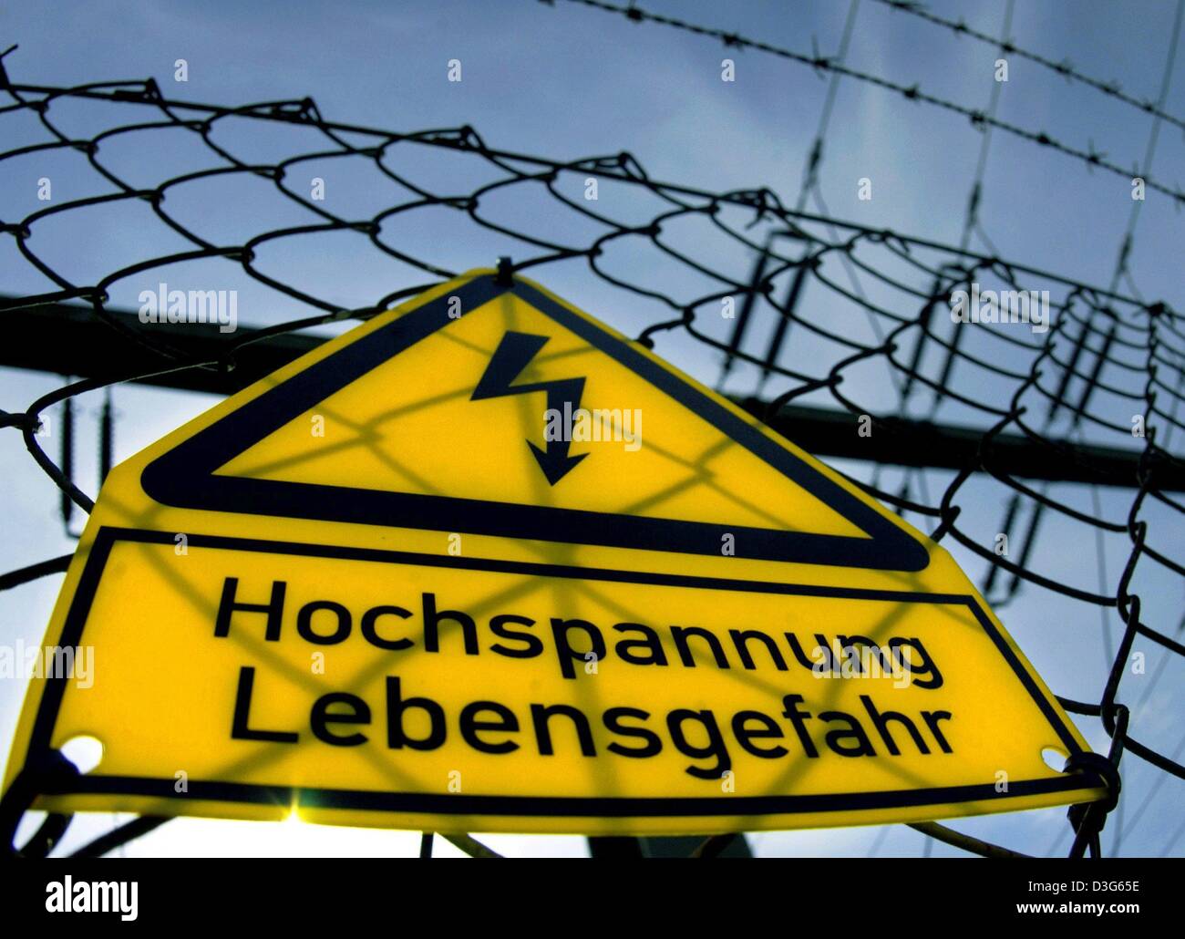 (Afp) - Le panneau d'avertissement jaune est attaché à une clôture métallique et lit 'Hochspannung - Lebensgefahr" (haute tension - danger de vie) dans les locaux de station de transformation près de Schwerin, Allemagne, 18 septembre 2003. Banque D'Images