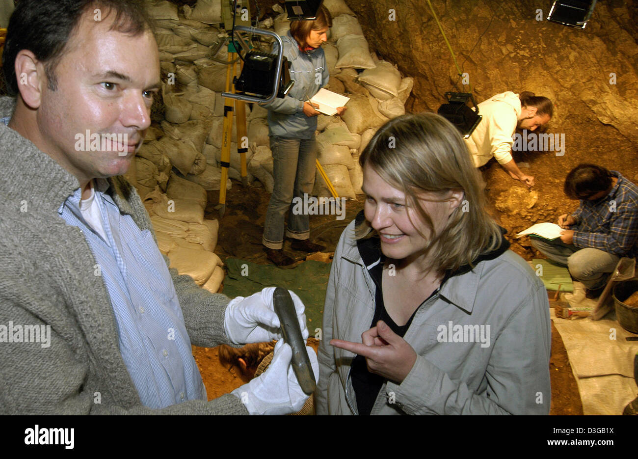 La photo montre Nicolas Conrad et Petra Kieselbach avec une pierre en forme de phallus préhistorique dans la grotte 'Hohle-Fels' près de Schelklingen, Allemagne, lundi 25 juillet 2005. Le phallus est de 30 000 ans, 20 cm de long et se compose d'un total de 14 fragments de pierre qui ont été trouvés lors des fouilles de l'Université de Tuebingen. Photo : Stefan Udry Banque D'Images