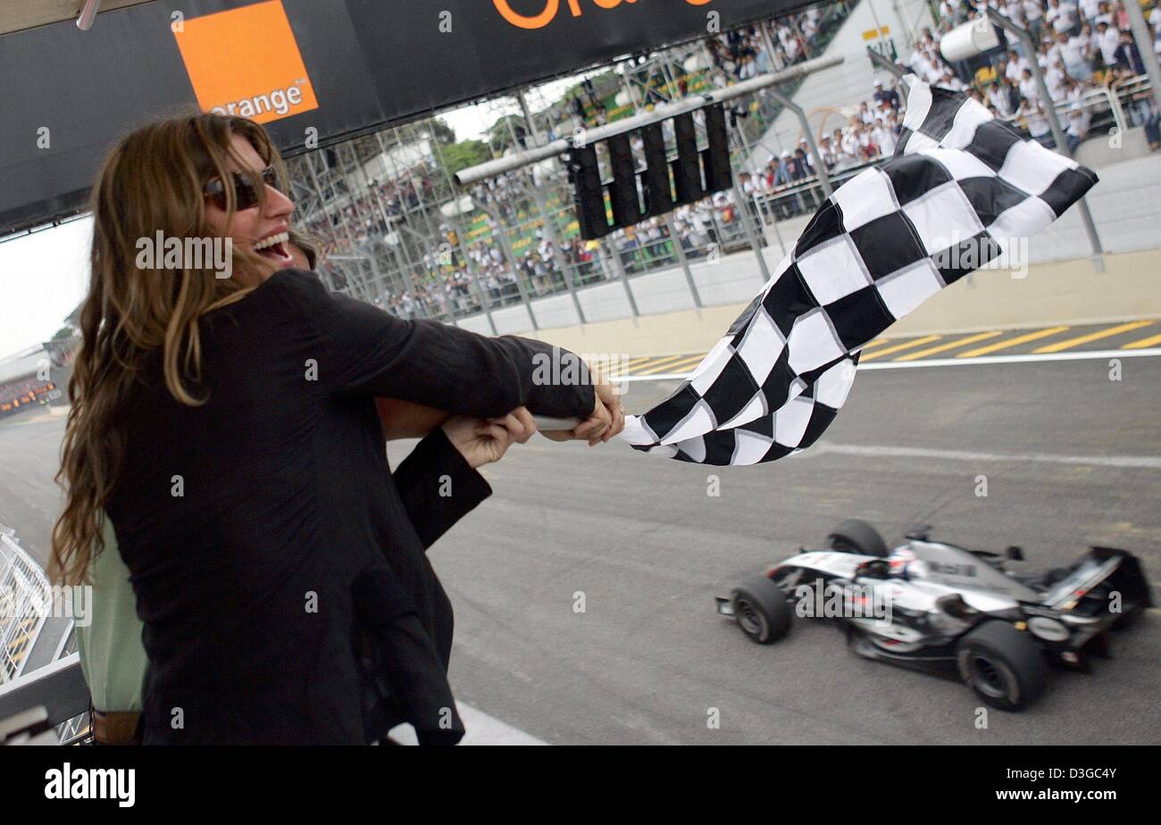 (Afp) - Le top model brésilien Gisele Bundchen vagues l'arrivée d'un drapeau au cours de la Formule Un Grand Prix du Brésil à Interlagos le circuit dans Sao Paulo, Brésil, dimanche 24 octobre 2004. Banque D'Images