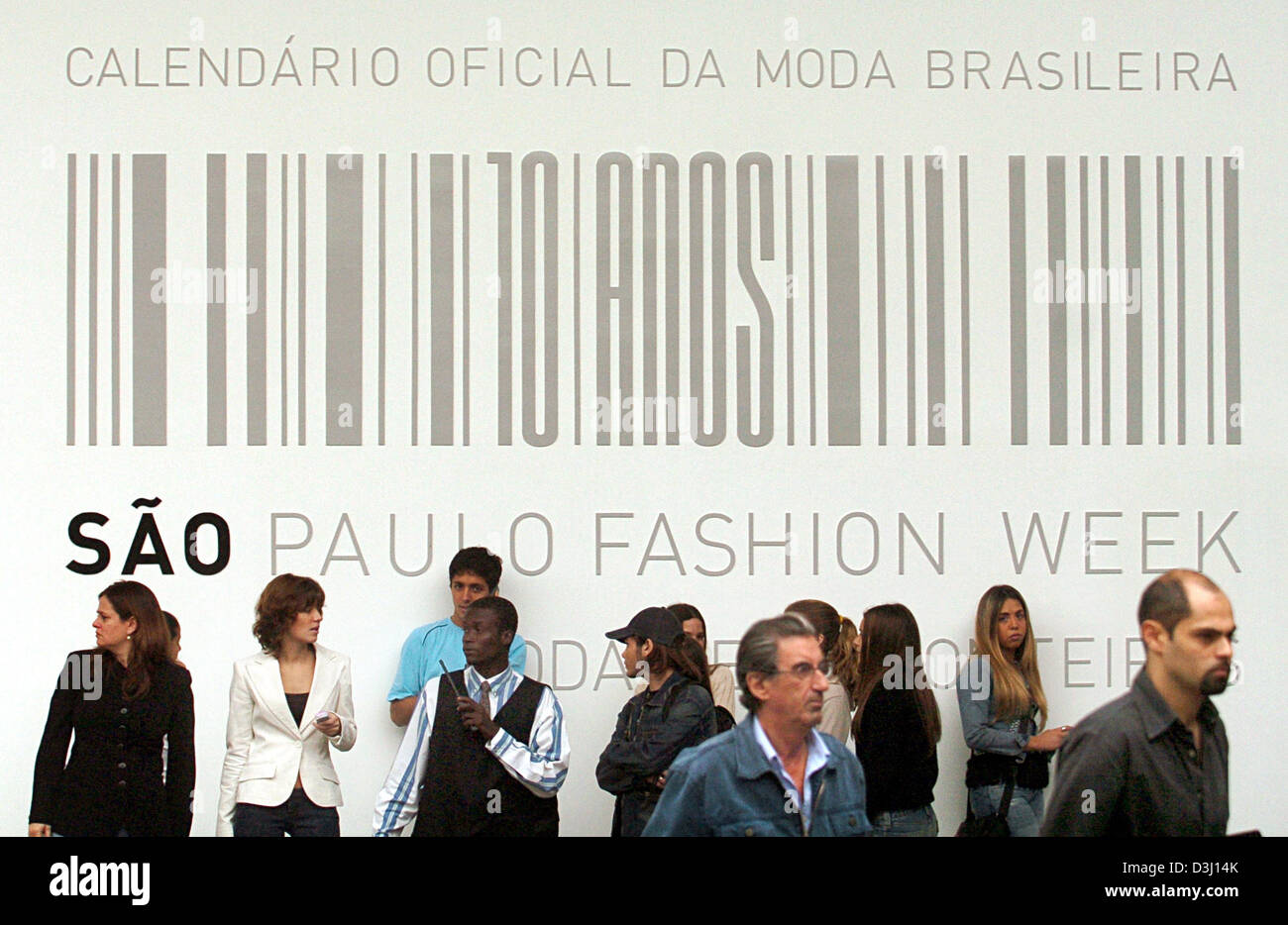(Afp) - Les visiteurs de la 10e semaine de la mode de Sao Paulo se tenir en face de la Fashion Week's logo avant la cérémonie d'ouverture officielle à le parc d'Ibirapuera à Sao Paulo, Brésil, 28 juin 2005. Dans les 7 jours les créateurs de mode brésilienne exposer leurs collections de l'été 2006. Banque D'Images