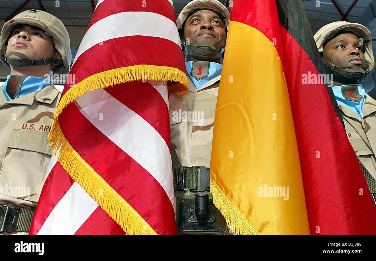 (Afp) - Trois soldats avec un allemand et un drapeau nous assister à la cérémonie de prise de congé de la 1re division d'infanterie de l'armée américaine à Würzburg, Allemagne, 30 janvier 2004. Environ 13 000 soldats américains de la région de Franconie sera déployée en Iraq pour une année. Banque D'Images