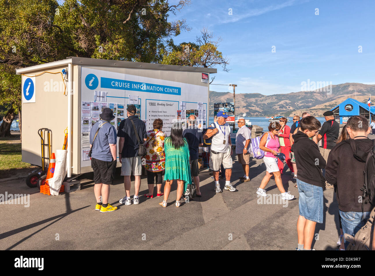 Les passagers des navires de croisière choisir leurs activités de la journée à Akaroa, Nouvelle-Zélande, un jour où quatre navires de croisière en visite. Banque D'Images