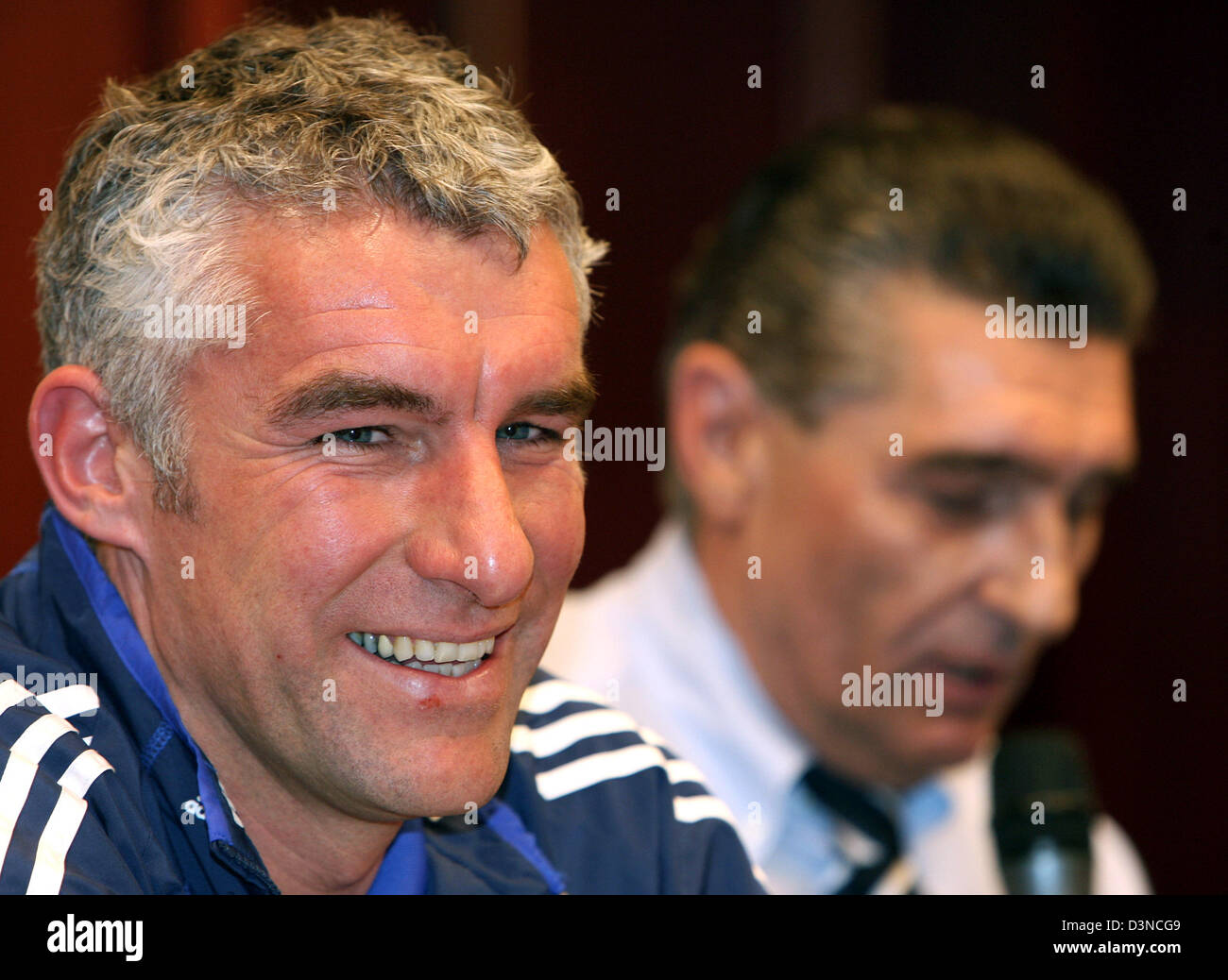 Le FC Schalke 04 entraîneur Mirko Slomka (L) sourit à côté manager Rudi Assauer lors d'une conférence de presse à Sofia, Bulgarie, le mercredi, 29 mars 2006. Le Losc Schalke se réunit dans le premier quart de finale de la Coupe de l'UEFA jeudi prochain sur la jambe. Photo : Achim Scheidemann Banque D'Images