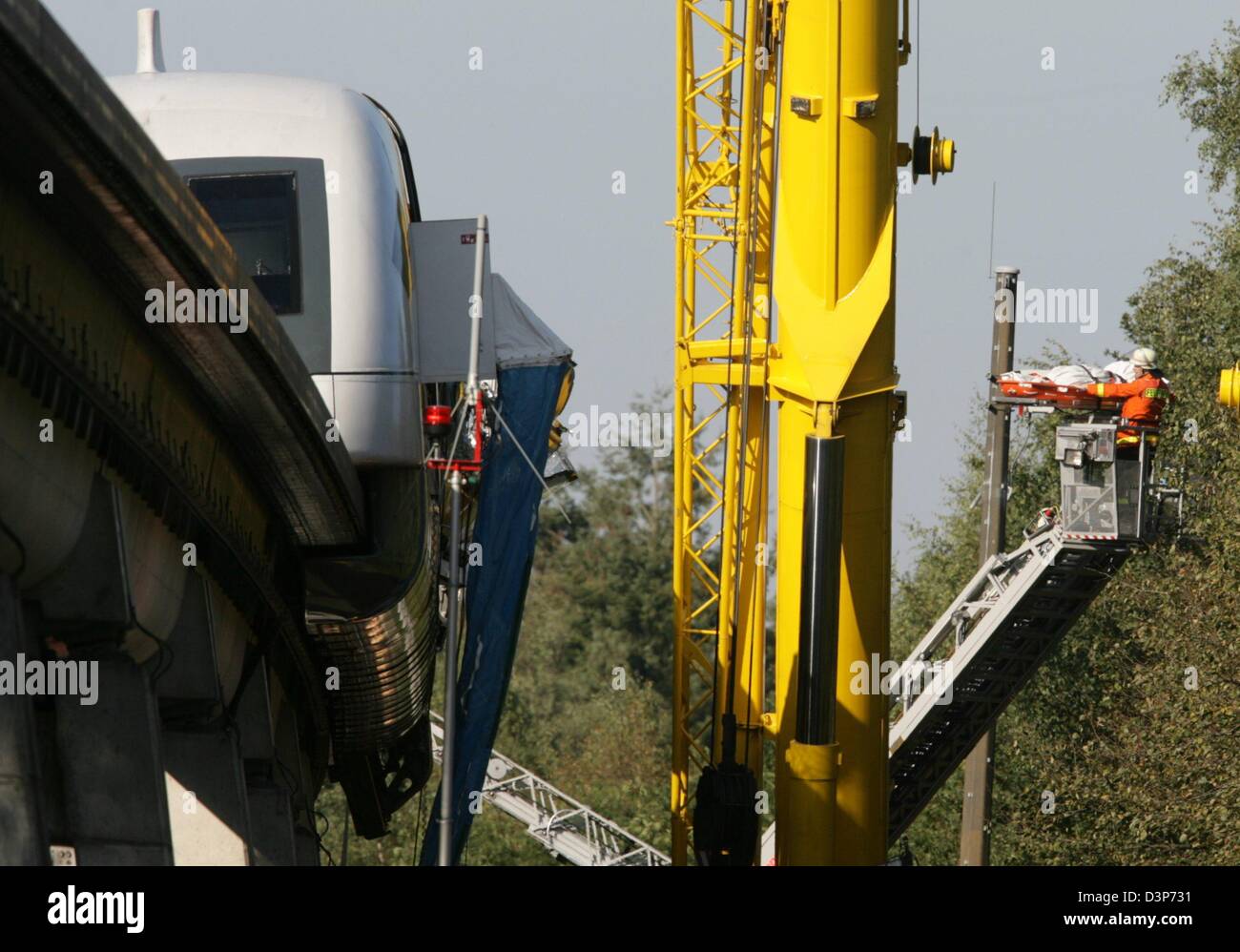 Les forces d'urgence sauver une personne hors de la 'endommagé' Transrapid maglev train debout à côté d'une grue à la voie d'essai 5m au-dessus du sol, en Allemagne, 22 Lathen, septembre 2006. Le train avec 25 passagers à bord a heurté un véhicule de maintenance de la voie à plus de 200km/h. Le travail de récupération est toujours en cours. Plusieurs personnes sont mortes et plusieurs ont été gravement blessées. Photo : Fede Banque D'Images