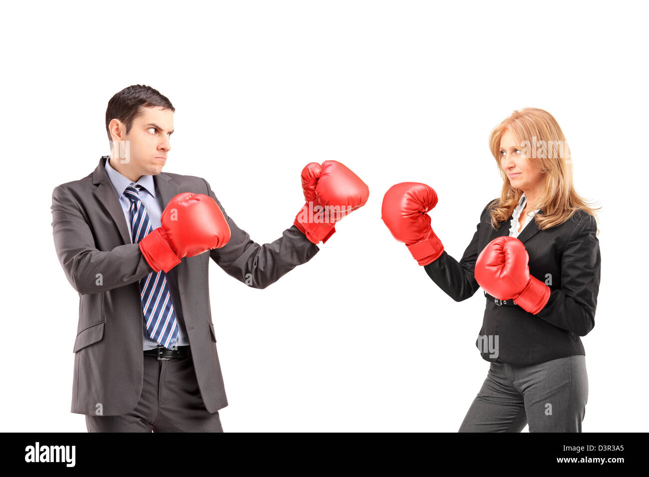 Businesswoman with boxing gloves ayant un combat avec un jeune homme d'isolé sur fond blanc Banque D'Images