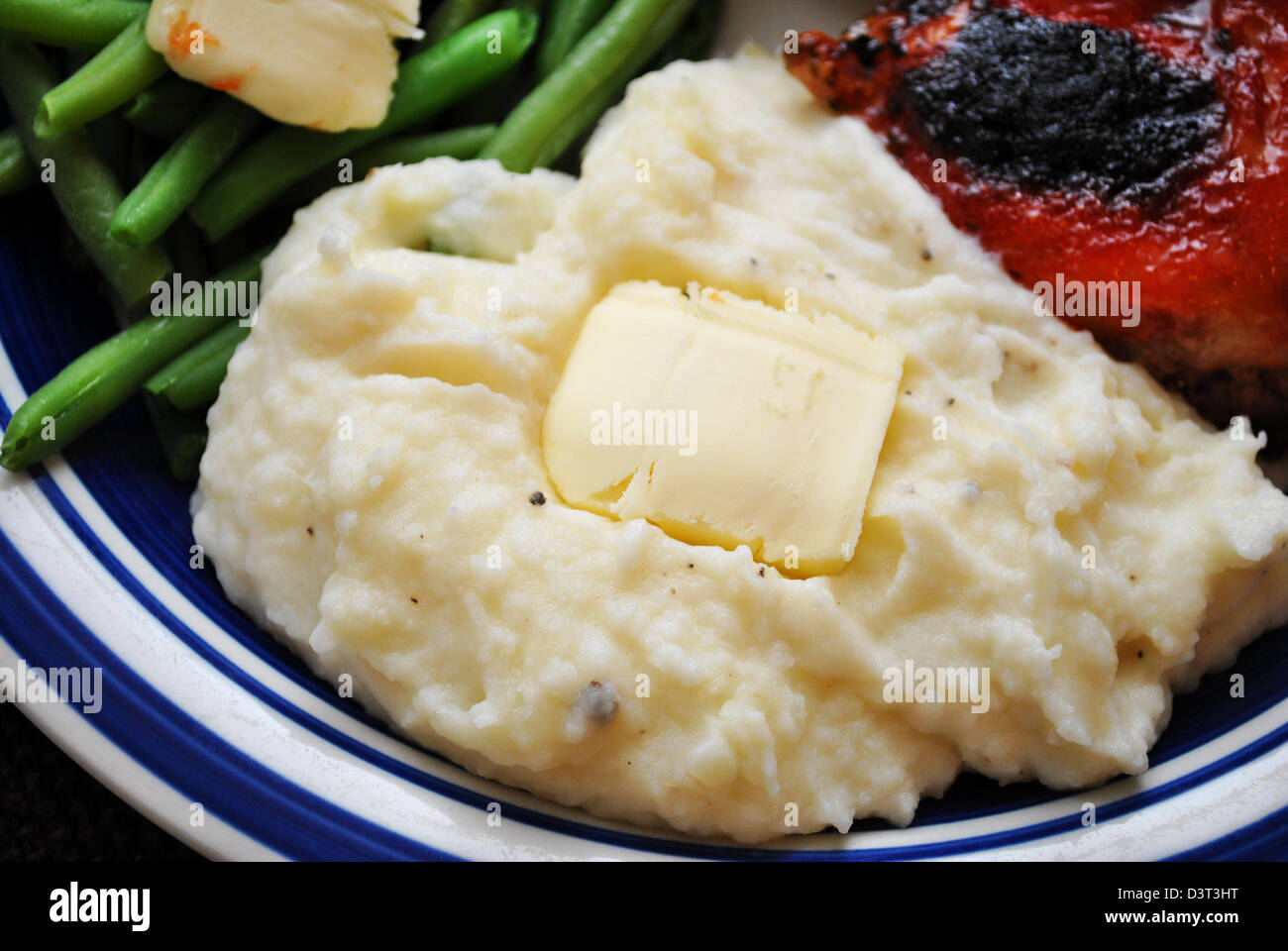 Accompagnement de purée de pommes de terre avec une noisette de beurre Banque D'Images