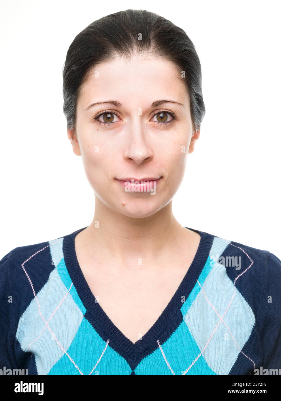 Portrait of young woman with hair up smiling with blue argyle pull v-cut Banque D'Images