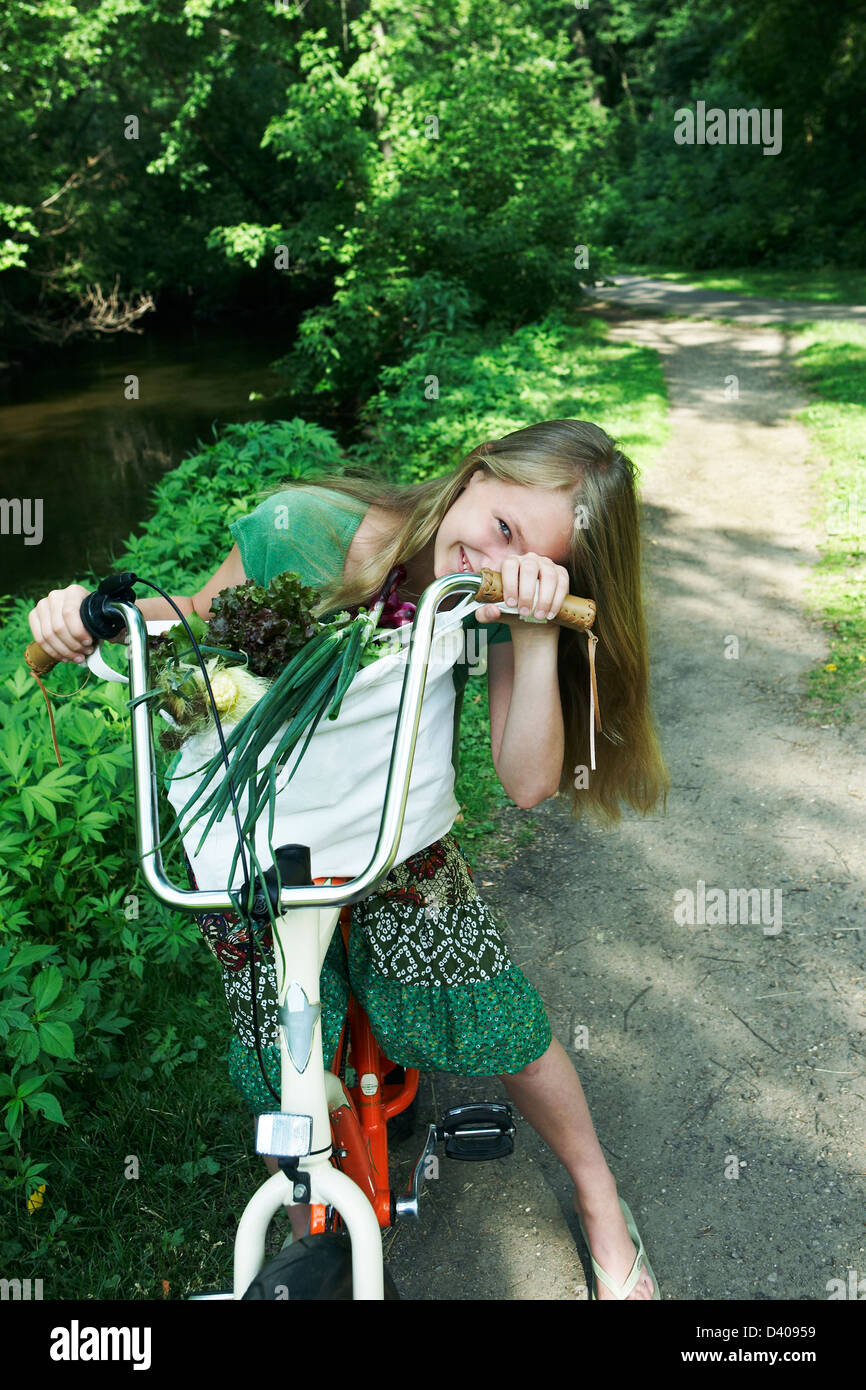 Girl riding bike avec les agriculteurs du marché Banque D'Images