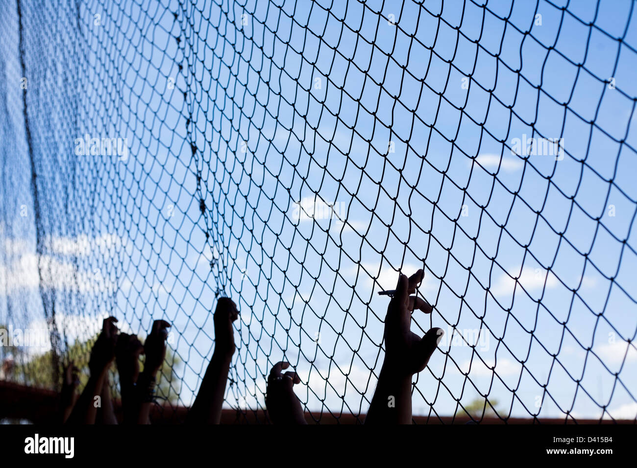 Fans et spectateurs regarder un match de baseball à Leon Nicaragua derrière le grillage. Banque D'Images