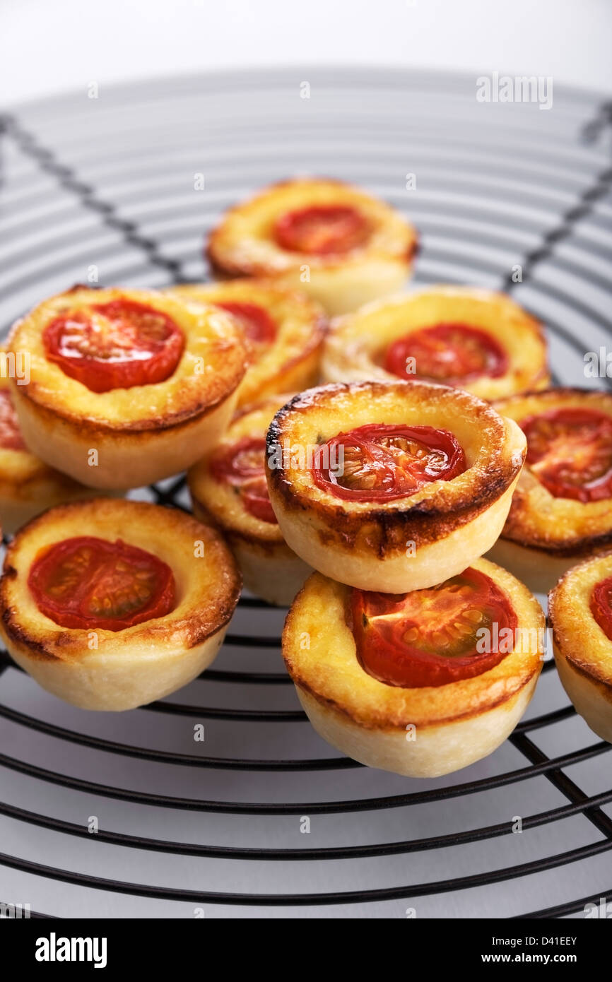 Mini quiches avec tomates, fromage et jambon fumé Banque D'Images