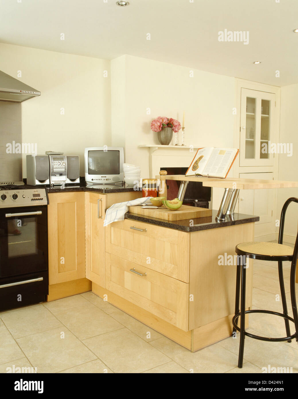 Petit à côté de la station de télévision de musique portable sur le plan de travail en hêtre cuisine moderne avec bar et tabouret en bois cintré et unités Banque D'Images