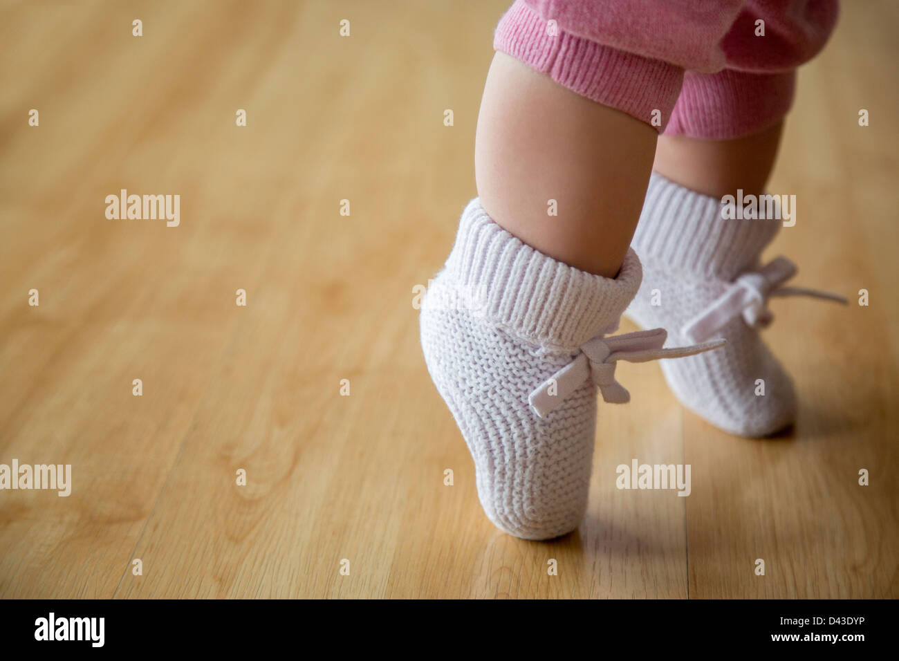 Baby Girl in pink booties Banque D'Images